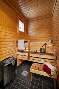 a sauna with a bench in a wooden cabin at Luoman Hirvimökit in Ähtäri +18 photos