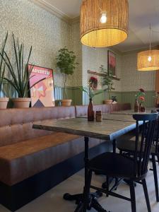 a table and chairs in a restaurant with plants at Gästisbacken in Alfta