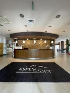 a store lobby with a black rug in the middle at Aspen Golf and Ski Resort in Bansko +104 photos