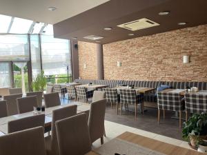 a restaurant with tables and chairs and a brick wall at Aspen Golf and Ski Resort in Bansko