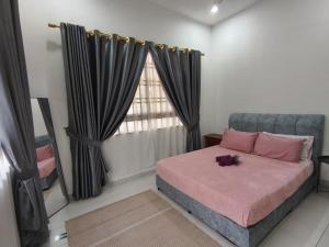 a bedroom with a bed with pink sheets and a window at FAs KLIA Guesthouse, 4BR 4 AC , NEAR KLIA, NILAI in Sepang
