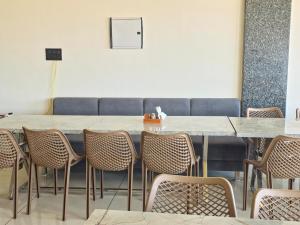 a dining room with a table and chairs at Hotel Keshav in Dhorīmanna