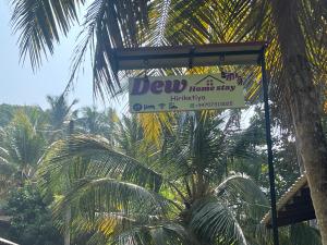 a sign for a honolulu home stay building at Dew home stay in Dickwella