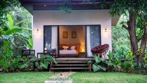 a hotel room with a bed and a bed and a room at Vilona Nature Villa in Dambulla