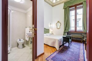 a hotel room with a bed and a bathroom at Affreschi Su Roma Luxury B&B in Rome +95 photos