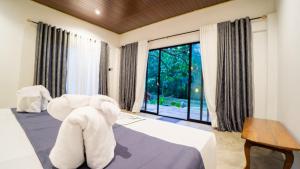 a room with a bed with an elephant sitting on it at Vilona Nature Villa in Dambulla
