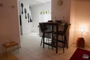 a dining room with a table and two chairs at LoveRoom Les Folies Douces & Spa in Nancy