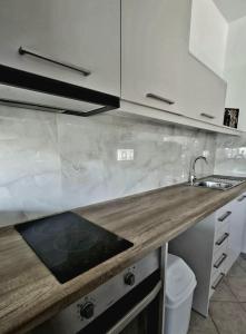 a kitchen with a sink and a counter top at Galazio suites 2 Seaside in Salamina +38 photos