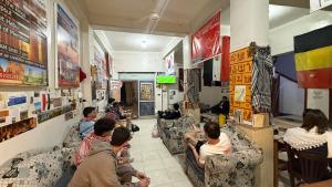 a group of people sitting on couches in a room at Grand Square Hostel Luxor in Luxor