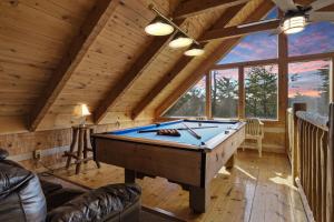 a room with a pool table in a cabin at Somewhere In Time cabin in Sevierville +18 photos