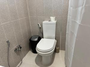 a bathroom with a white toilet and a shower at Le cocon éclatant in Sfax +7 photos