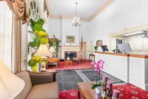 a living room with a couch and a fireplace at Rodeway Inn Williamsburg Historic Area in Williamsburg