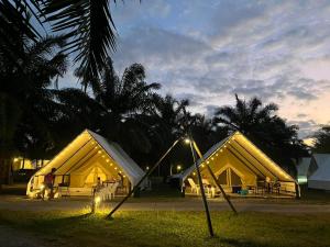 a group of tents with lights in the grass at khaolakcamping in Ban Lam Ru (1)