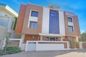 a building with a large sign in front of it at FabHotel Sandalwood Vibes in Bhopal