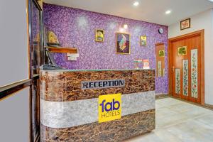 a restaurant with a purple wall with a sign on it at FabHotel Sandalwood Vibes in Bhopal