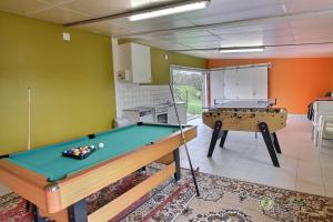 a kitchen with a pool table in a room at Le logis in Plouguenast