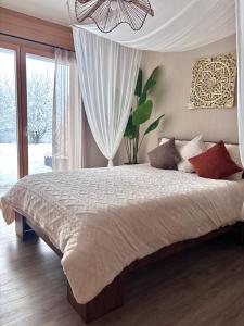 a bedroom with a large bed and a window at Lake View in Le Sentier