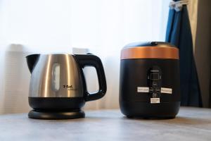 two coffeemakers sitting next to each other on a counter at Tanuki Inn Korien Kyoto Osaka in Neyagawa