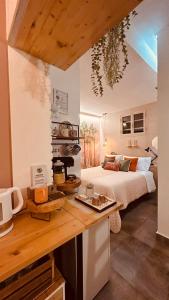 a bedroom with a bed and a kitchen with a table at BBSUITE21 Maranello in Maranello