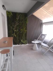 a living room with a plant on the wall at Nature Nest in Larisa