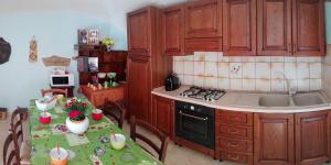 a kitchen with a table and a stove top oven at B&B Oasi Tepilora in Bitti