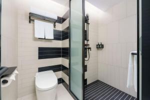 a bathroom with a toilet and a shower at Ibis Dalian Development Zone Wanda Plaza in Jinzhou