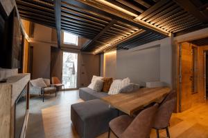 a living room with a couch and a table at Le Suites de San Campel RTA in Ponte di Legno