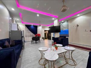 a living room with a couch and tables and a tv at شاليهات سكون الغروب in Taif