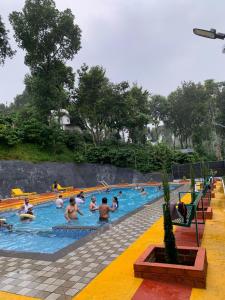 a group of people in a swimming pool at Pepper Valley Resort in Kalpetta