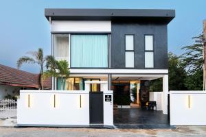 a house with a black and white facade at Indiluxe pool villa in Pattaya South