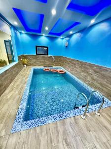 a swimming pool in a room with a blue ceiling at شاليهات سكون الغروب in Taif