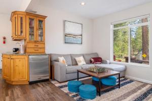 a living room with a couch and a table at Recharge by The River by NW Comfy Cabins in Leavenworth +58 photos
