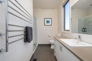 a bathroom with a sink and a toilet at Blue Horizons at Ocean Grove in Ocean Grove +29 photos