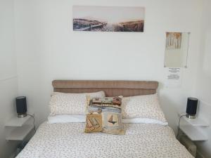 a bedroom with a bed with two pillows on it at Ashton Holiday Flats Seaviews in Bridlington