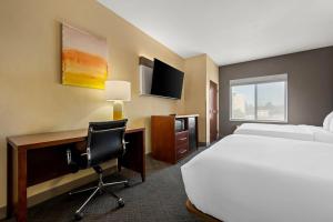 a hotel room with a bed and a desk with a computer at Comfort Suites Cullman I-65 Exit 310 in Cullman