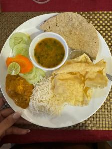 a plate of food with a plate of food with rice and beans at Hotel The White Castle Kargil in Kargil