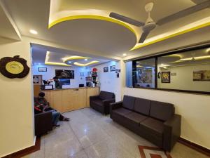 a waiting room with two people sitting on couches at Hotel The White Castle Kargil in Kargil