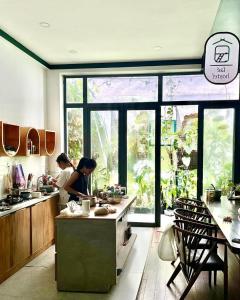 two women standing in a kitchen preparing food at Laé Hostel in Tuy Hoa