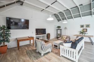 a living room with a couch and a tv at Hoekkraaltjie in Yzerfontein