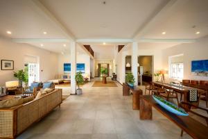 a large living room with couches and tables at On The Rocks Villa in Unawatuna