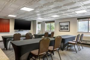a conference room with tables and chairs and a flat screen tv at Comfort Inn University in Amherst +39 photos