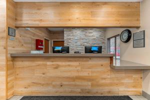 an office with wooden walls and a clock on the wall at Country Inn & Suites by Radisson, Fairview Heights, IL in Fairview Heights