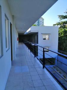 an empty hallway of a building with a balcony at Rana Hotel in Sampong