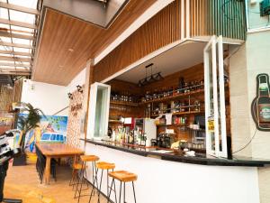 a restaurant with a bar with stools and a table at Turtle Beach Resort in San Juan