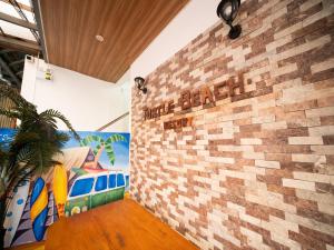 a brick wall in a room with a mural at Turtle Beach Resort in San Juan