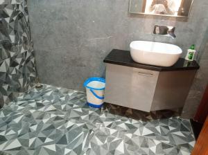 a bathroom with a sink and a mirror at sariska farmhouse villa in Alwar