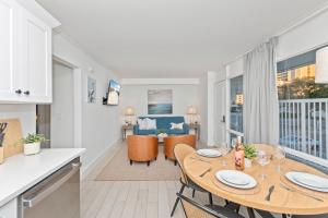 a kitchen and living room with a table and chairs at Fin's Inn & Suites in Myrtle Beach