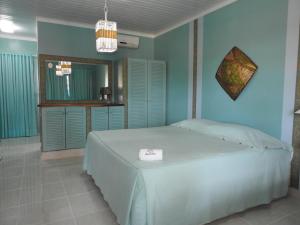 a bedroom with a large bed with a mirror at Fazenda Fiore Resort in Paripueira +229 photos