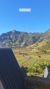 a view of a farm with mountains in the background at Secret valley vattavada in Vattavada +4 photos