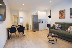 a living room with a couch and a table and chairs at Apartamento Terra in Benajarafe
